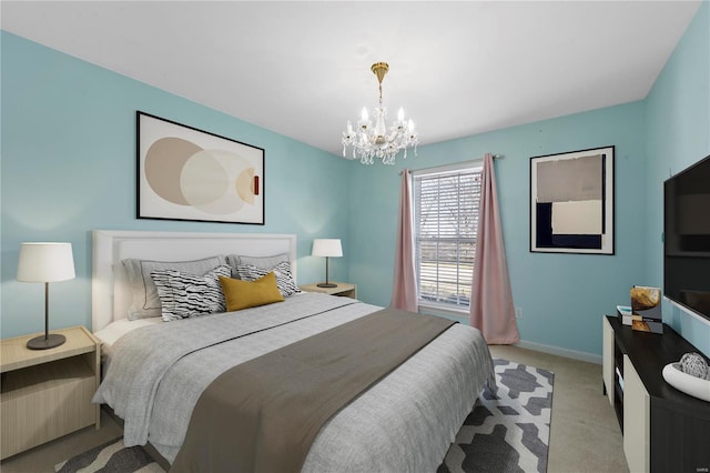 carpeted bedroom with baseboards and a notable chandelier