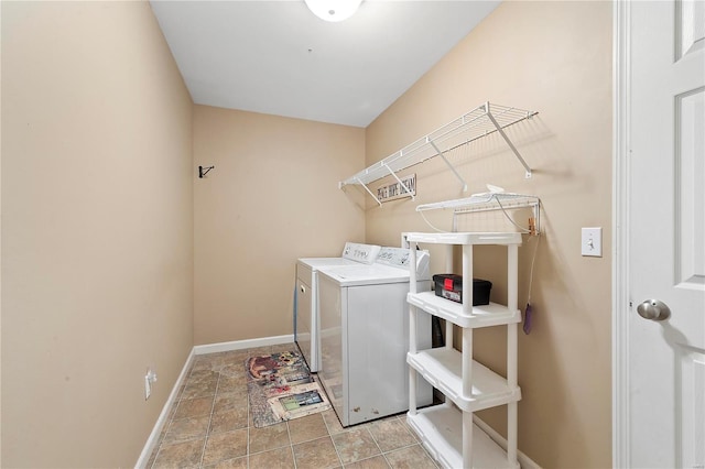 clothes washing area featuring laundry area, baseboards, and separate washer and dryer