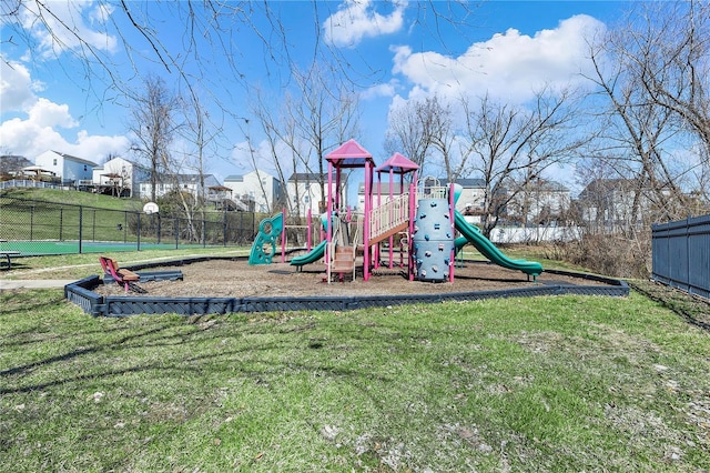 community playground featuring fence and a lawn