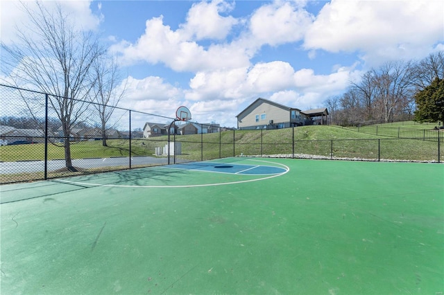 view of basketball court with community basketball court and fence