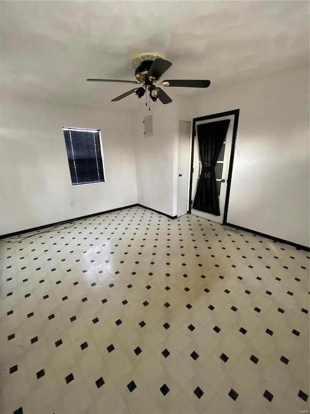 unfurnished room featuring baseboards and a ceiling fan