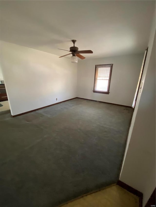 empty room with baseboards and ceiling fan