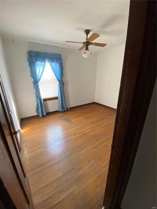 unfurnished room featuring ceiling fan and wood finished floors