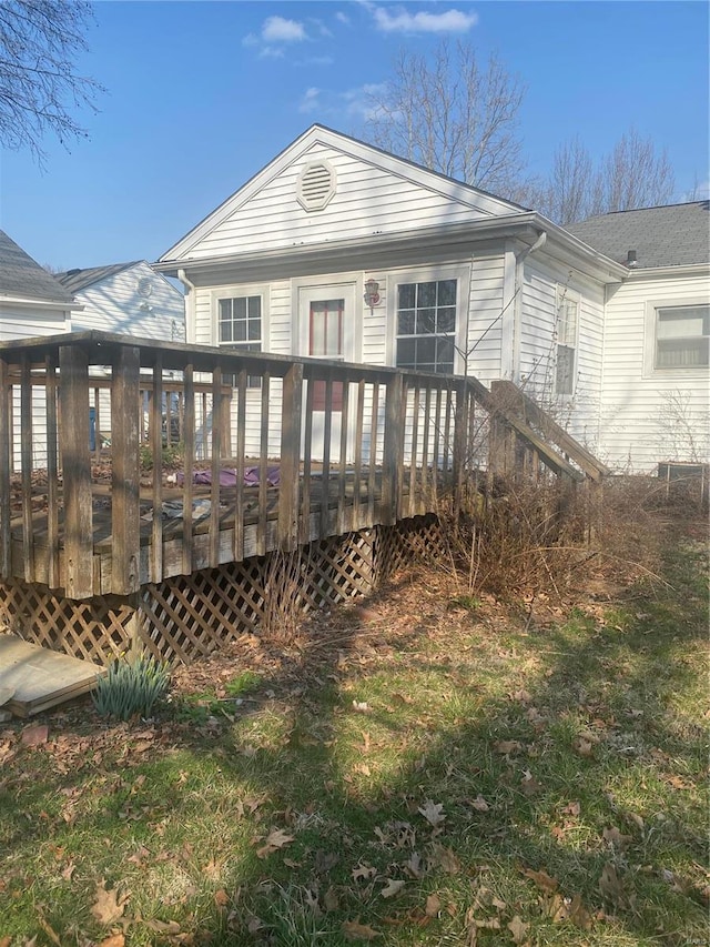 back of house featuring a wooden deck