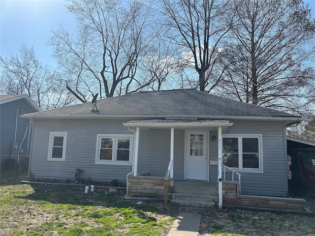 bungalow-style house featuring roof with shingles