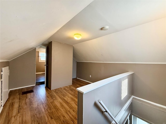 additional living space with lofted ceiling and wood finished floors