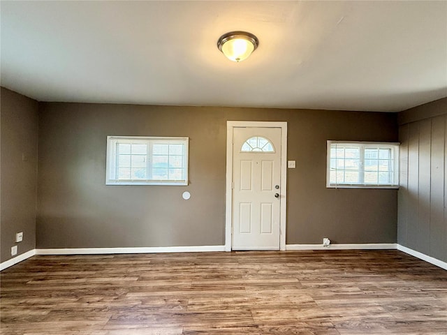 foyer entrance with wood finished floors and baseboards