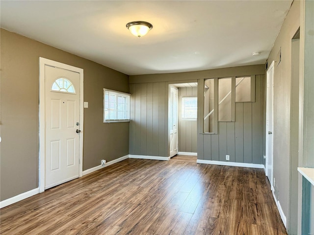 entrance foyer featuring stairs, baseboards, and wood finished floors