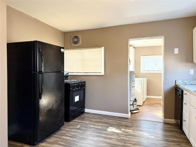 kitchen featuring visible vents, baseboards, dark wood finished floors, white cabinets, and black appliances