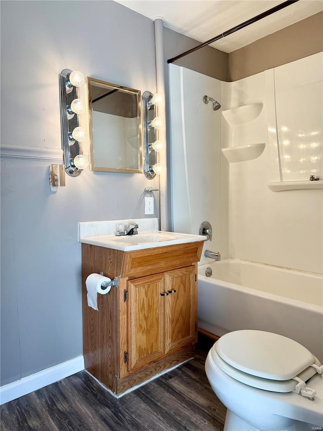 full bathroom featuring vanity,  shower combination, wood finished floors, and baseboards