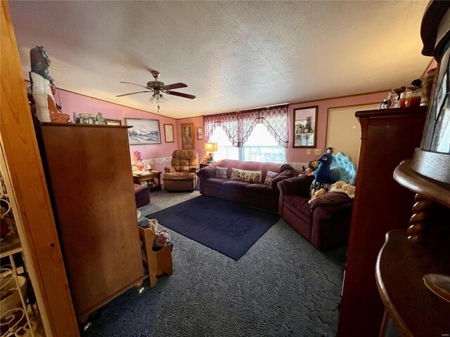 living area featuring ceiling fan, vaulted ceiling, carpet, and a textured ceiling