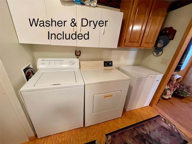 washroom with cabinet space, washing machine and dryer, and light wood-type flooring