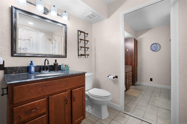 bathroom featuring tile patterned floors, visible vents, toilet, baseboards, and vanity