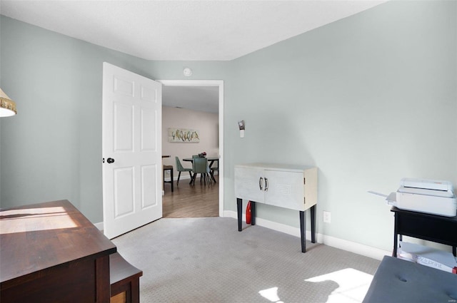 home office with baseboards and carpet