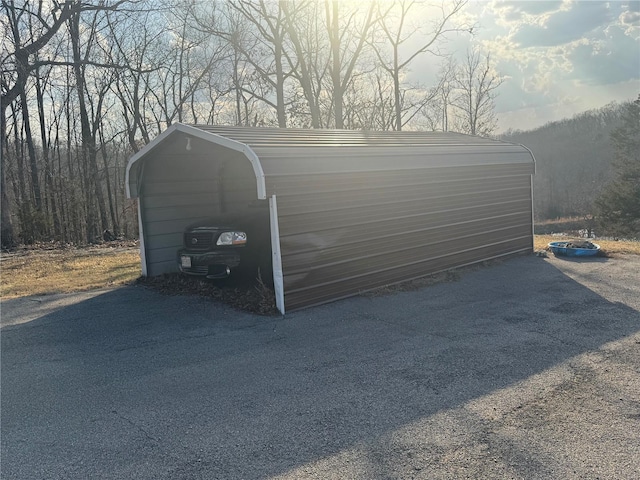 garage featuring a carport and driveway