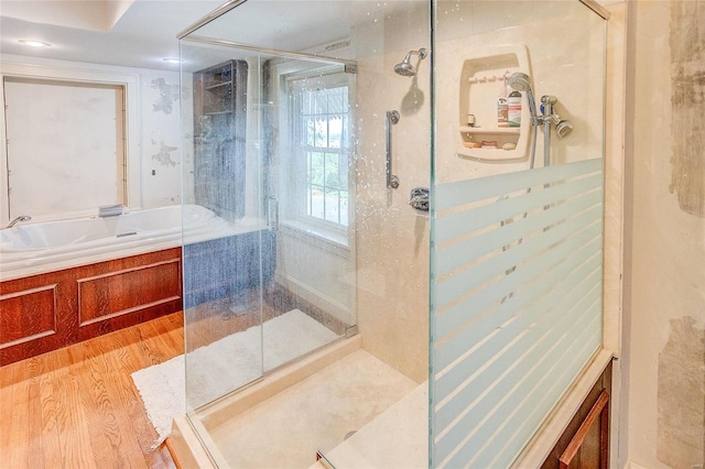 full bath with wood finished floors and a stall shower