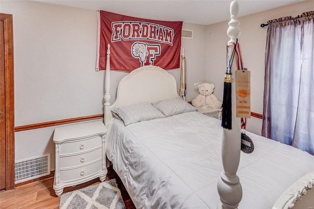 bedroom with wood finished floors and visible vents