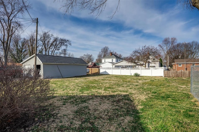 view of yard featuring an outbuilding and fence