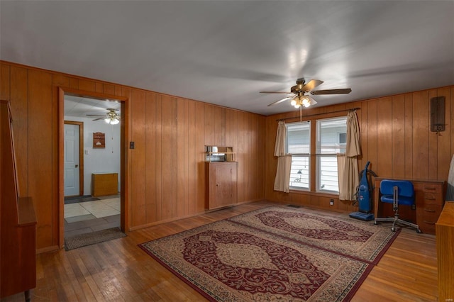 interior space featuring visible vents, wood-type flooring, and ceiling fan