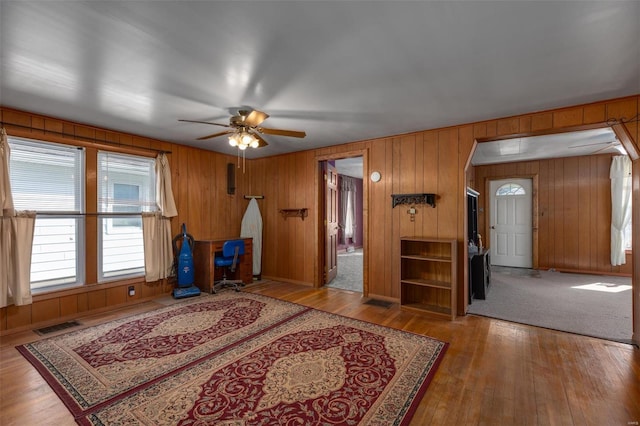 interior space with wood finished floors, visible vents, and ceiling fan