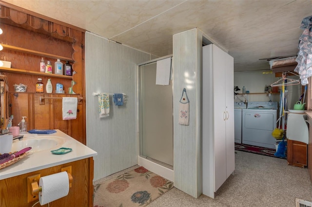 bathroom featuring visible vents, separate washer and dryer, a stall shower, and vanity