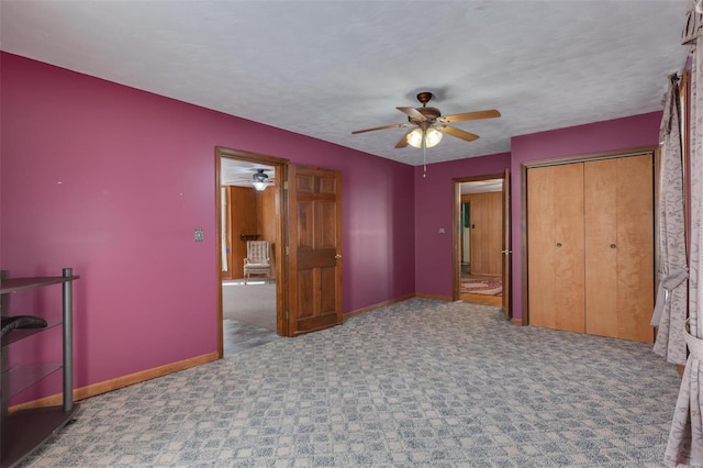 unfurnished bedroom with a closet, baseboards, carpet floors, and a textured ceiling