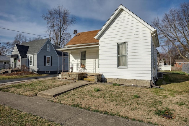 bungalow with a porch and a front lawn