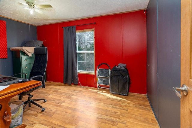 home office with a textured ceiling and wood finished floors