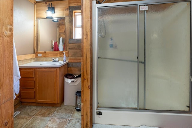 bathroom featuring tile patterned flooring, visible vents, vanity, and a shower with shower door