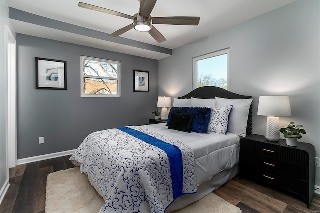 bedroom featuring ceiling fan, baseboards, and wood finished floors