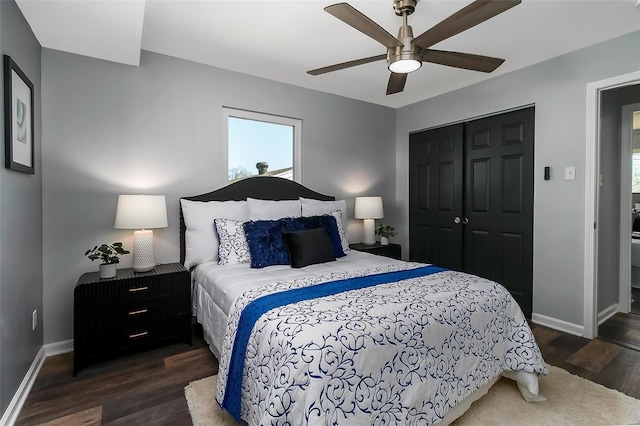 bedroom with dark wood-style floors, baseboards, a closet, and a ceiling fan