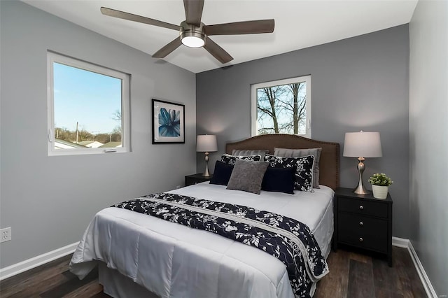 bedroom with ceiling fan, baseboards, and wood finished floors