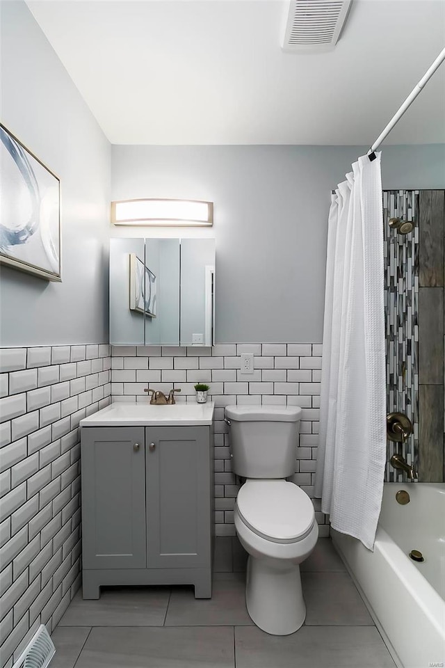 full bath with tile walls, shower / bath combination with curtain, toilet, and visible vents