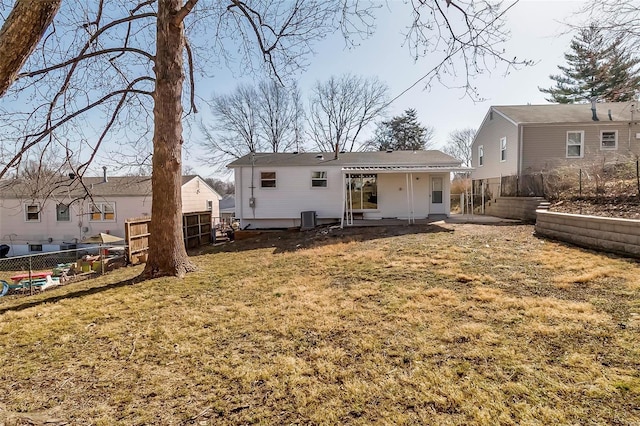 rear view of house with a patio, cooling unit, fence, and a lawn