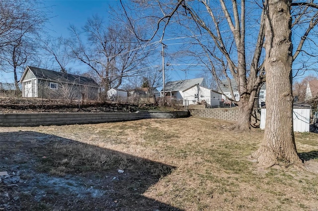 view of yard featuring an outdoor structure and fence