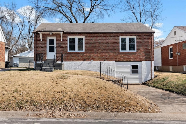 view of front of house featuring a front lawn, a garage, brick siding, and a shingled roof