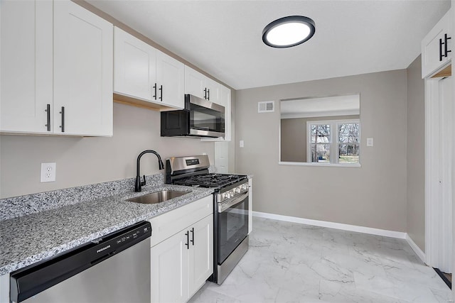 kitchen with visible vents, baseboards, marble finish floor, stainless steel appliances, and a sink