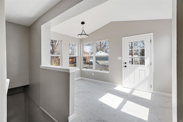 unfurnished dining area with vaulted ceiling, baseboards, and marble finish floor