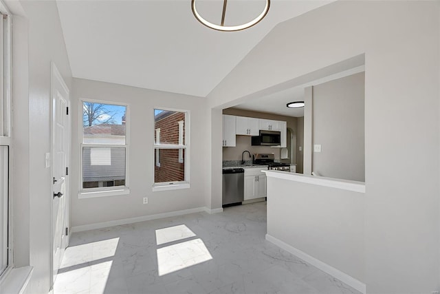 entryway featuring baseboards, marble finish floor, and vaulted ceiling