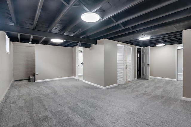 finished basement featuring baseboards and carpet floors