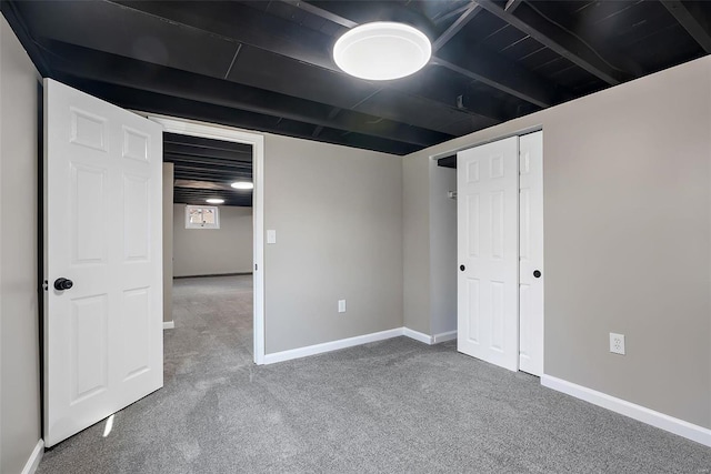 interior space featuring carpet and baseboards