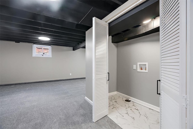 basement featuring baseboards and marble finish floor