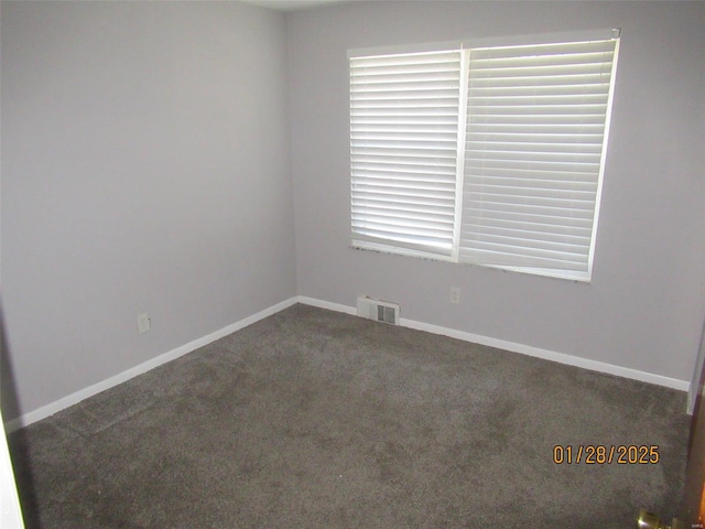 carpeted spare room with baseboards and visible vents