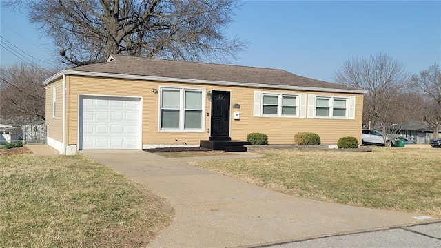 single story home with a garage, concrete driveway, and a front yard