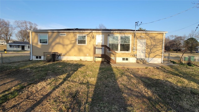 rear view of property with a patio area, central AC, a yard, and fence