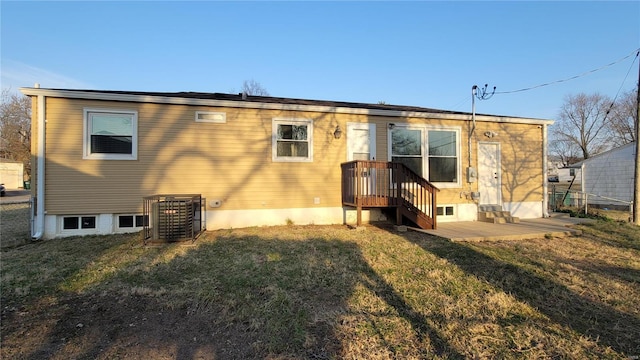 rear view of property featuring a yard and fence