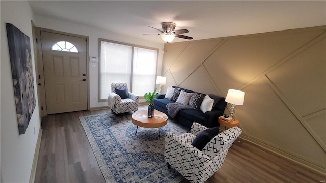 living room featuring a ceiling fan and wood finished floors