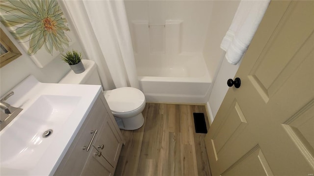 full bath with toilet, vanity, shower / tub combo, and wood finished floors