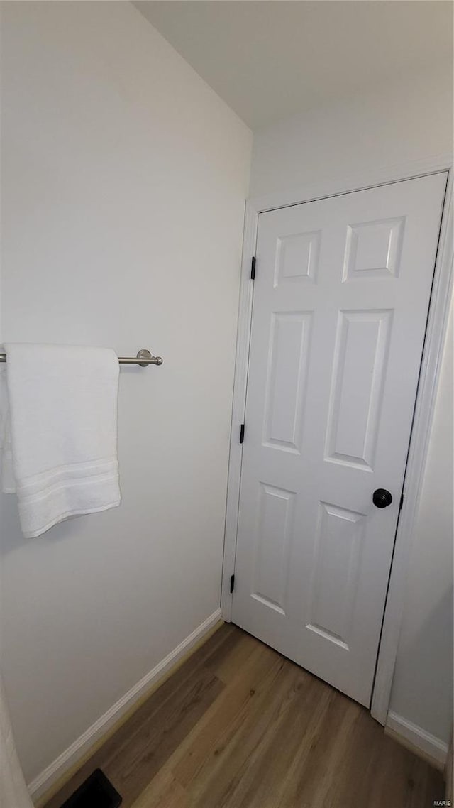 bathroom featuring baseboards and wood finished floors