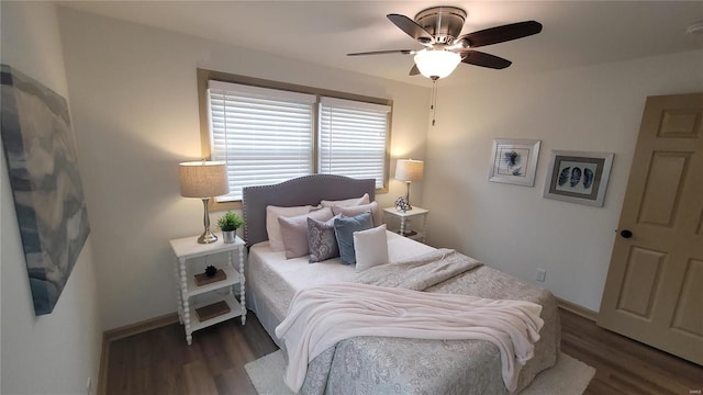 bedroom featuring a ceiling fan, baseboards, and wood finished floors